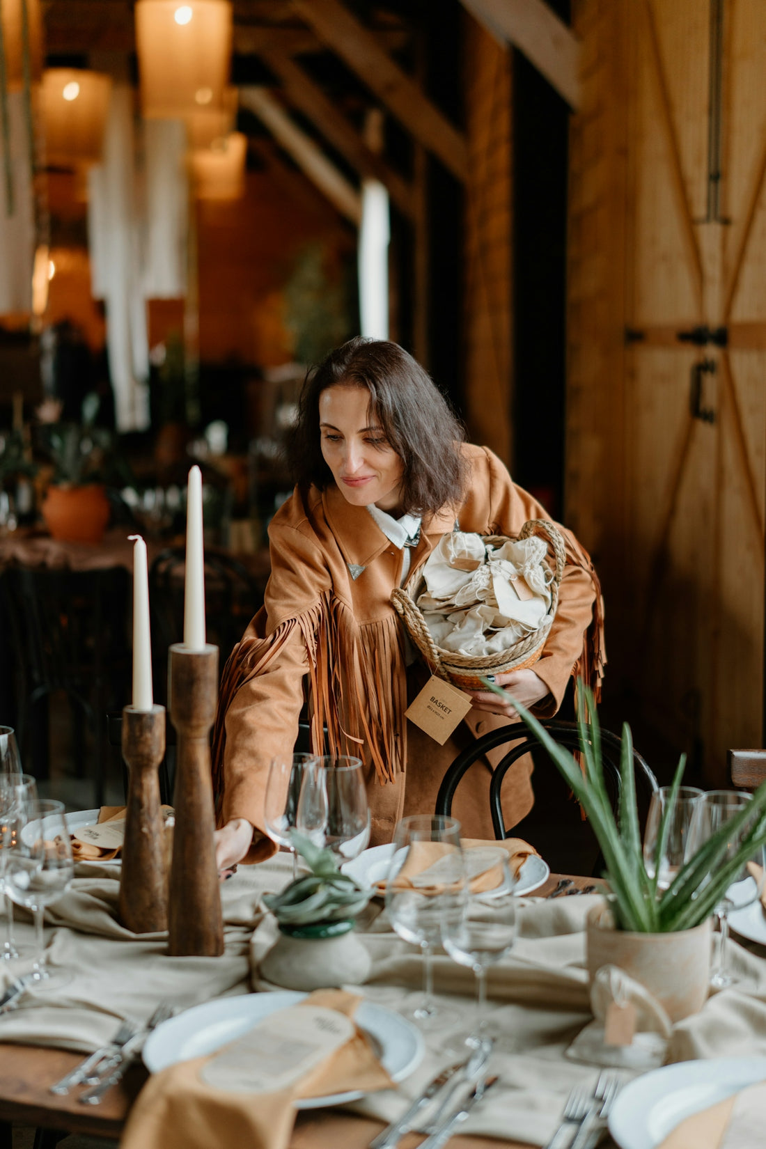 Woman arranging table setting with bread basket