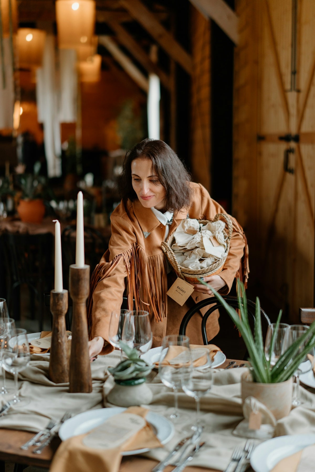 Woman arranging table setting with bread basket
